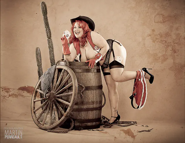 A pin-up cowgirl leaning on a barrel