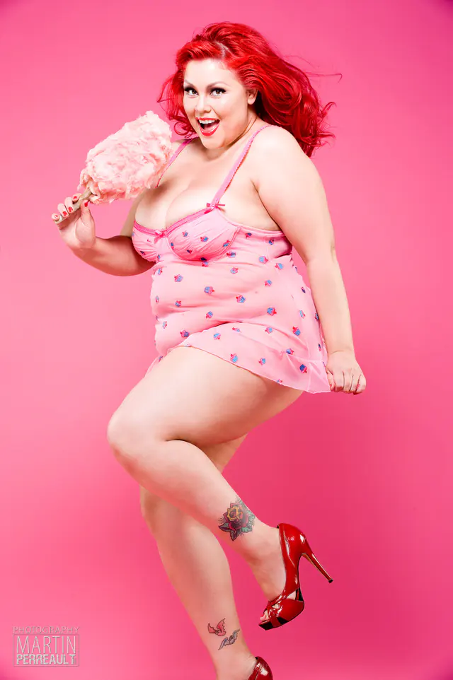A pin-up model in pink, holding cotton candy