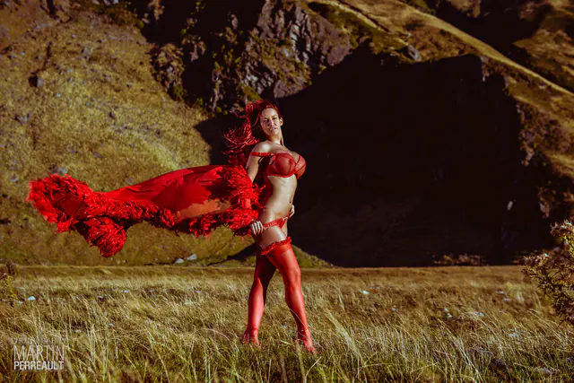 Bianca Beauchamp with a red scarf flying, in a field at dusk