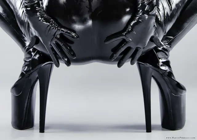 Black latex gloves and platform heels, close up