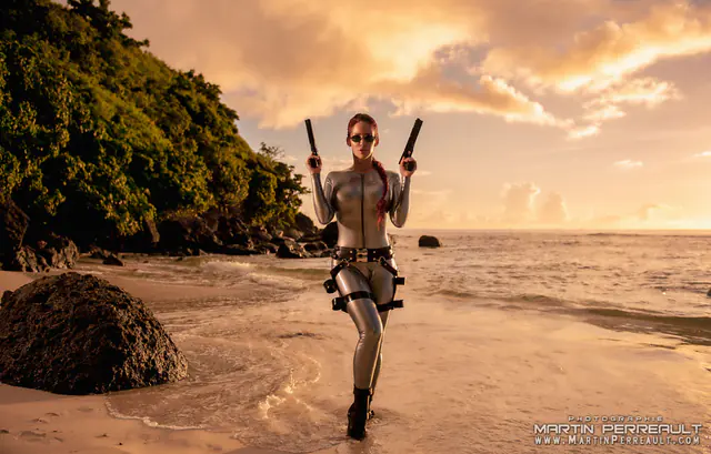 Bianca Beauchamp as an adventurer walking on a beach at sunset