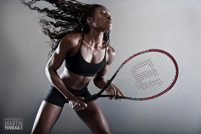 A tennis player swinging a racket, her hair flying