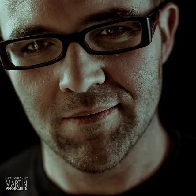 A man in black glasses, close portrait