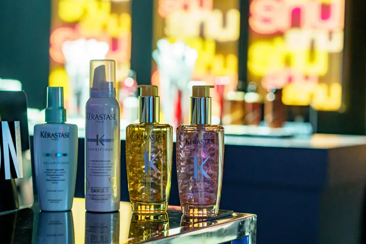 Kérastase haircare bottles on a lit counter