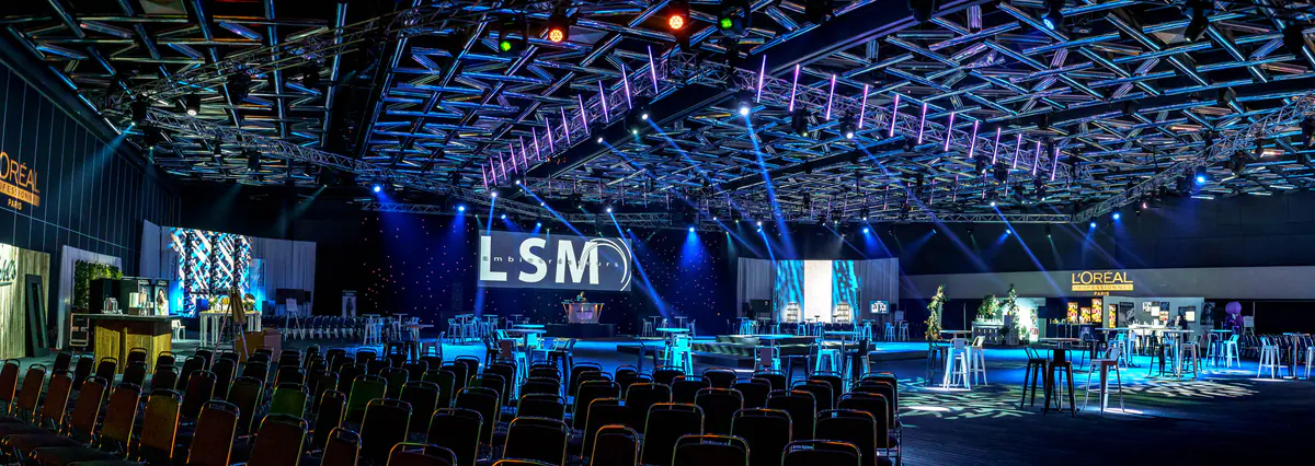 Wide view of the hall with the LSM stand and lounge tables