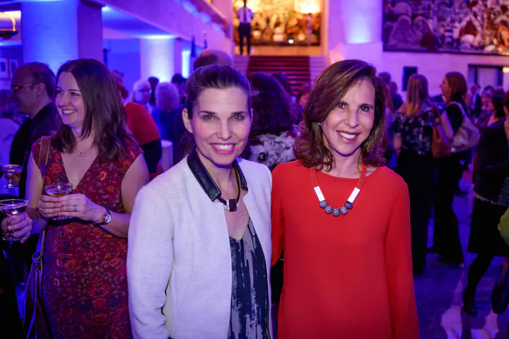 Guests posing in the hall under purple light