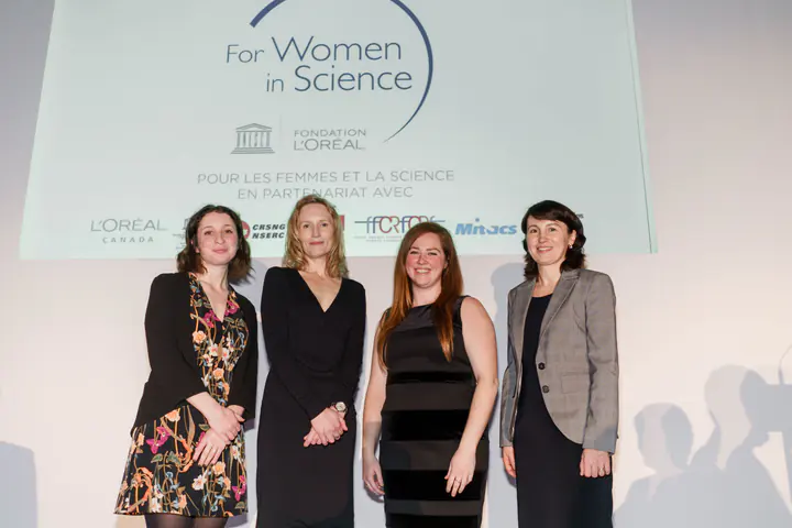 Four guests in front of the For Women in Science backdrop