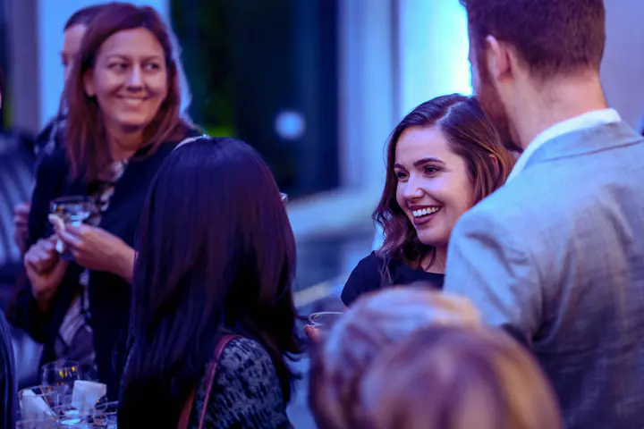 Guests talking and smiling at the reception
